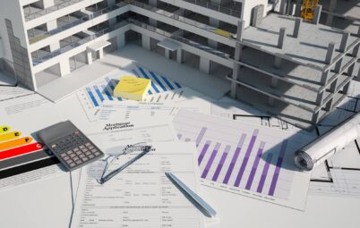 3D model of a property in construction on a table with paperwork.