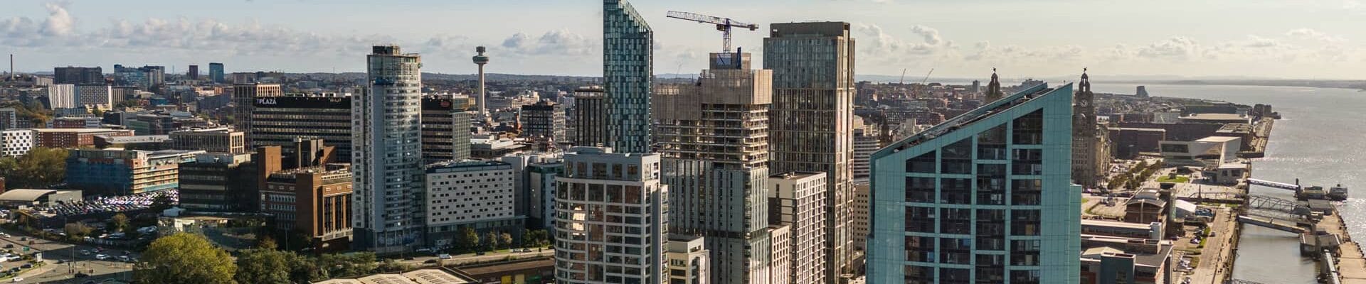An aerial shot of the Liverpool skyline with cranes in the background.